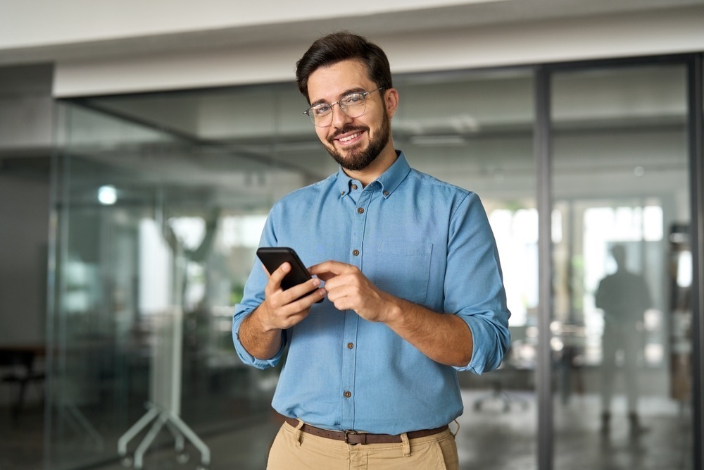 Smiling,Busy,Professional,Latin,Business,Man,Standing,In,Office,Holding